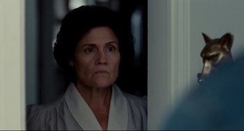 Movie still from “Foxcatcher” (2014), directed by Bennett Miller – An older woman in a white robe looking at the camera; Close Up shot, Over the shoulder angle