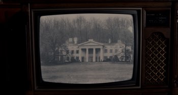 Movie still from “Foxcatcher” (2014), directed by Bennett Miller – An old television screen with a picture of a white house; Extreme Wide shot, High angle