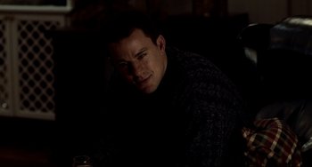 Movie still from “Foxcatcher” (2014), directed by Bennett Miller – A man sitting in a dark room with a glass of wine; Close Up shot, Over the shoulder angle