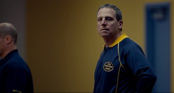 Movie still from “Foxcatcher” (2014), directed by Bennett Miller – A person standing in a room; Close Up shot, Low angle
