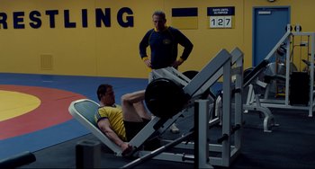 Movie still from “Foxcatcher” (2014), directed by Bennett Miller – Two men are working out in a gym; Wide shot, Over the shoulder angle