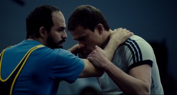 Movie still from “Foxcatcher” (2014), directed by Bennett Miller – Two men are wrestling in a room; Close Up shot, Low angle