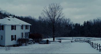 Movie still from “Foxcatcher” (2014), directed by Bennett Miller – A person standing in the snow next to a tree; Extreme Wide shot, Low angle