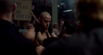 Movie still from “Foxcatcher” (2014), directed by Bennett Miller – A man getting ready for a boxing match in front of an audience; Medium shot, Over the shoulder angle
