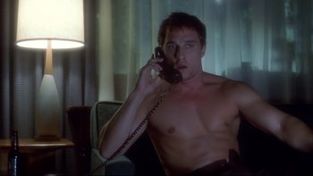 Movie still from “Frailty” (2001), directed by Bill Paxton – A man sitting in a chair talking on a phone; Medium shot, High angle