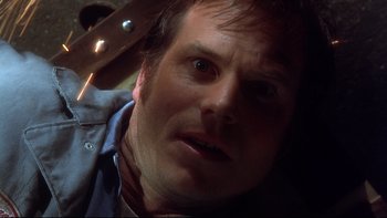 Movie still from “Frailty” (2001), directed by Bill Paxton – A person with a knife in his hand; Close Up shot, Overhead angle