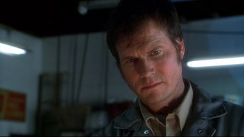 Movie still from “Frailty” (2001), directed by Bill Paxton – A person wearing a shirt and jacket; Close Up shot, Low angle