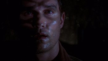Movie still from “Frailty” (2001), directed by Bill Paxton – A person's face in the dark; Close Up shot, Low angle