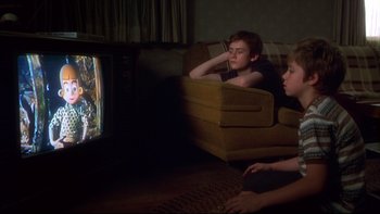 Movie still from “Frailty” (2001), directed by Bill Paxton – Two young boys sitting on a couch watching television; Medium shot, High angle