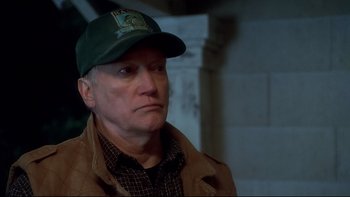 Movie still from “Frailty” (2001), directed by Bill Paxton – An older man wearing a hat and a jacket; Close Up shot, High angle