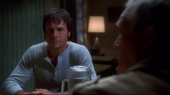 Movie still from “Frailty” (2001), directed by Bill Paxton – A man sitting in front of a mirror in a room; Close Up shot, Over the shoulder angle