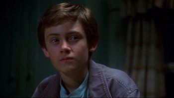 Movie still from “Frailty” (2001), directed by Bill Paxton – A young boy is looking into the distance; Close Up shot, Low angle