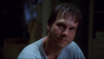 Movie still from “Frailty” (2001), directed by Bill Paxton – A person wearing a white shirt; Close Up shot, Over the shoulder angle