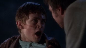 Movie still from “Frailty” (2001), directed by Bill Paxton – A young boy with blood all over his face; Close Up shot, Over the shoulder angle