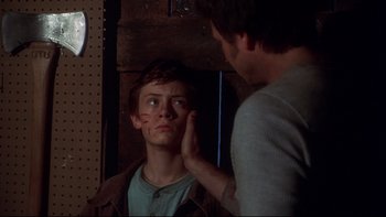 Movie still from “Frailty” (2001), directed by Bill Paxton – A young man looking at his reflection in a mirror; Close Up shot, Over the shoulder angle