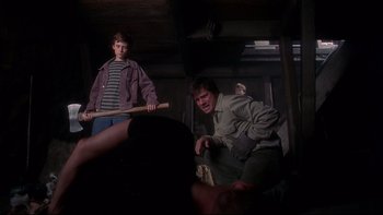 Movie still from “Frailty” (2001), directed by Bill Paxton – Two men are playing a game in a room; Medium shot, Low angle