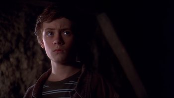 Movie still from “Frailty” (2001), directed by Bill Paxton – A young man is looking at the camera; Close Up shot, Low angle