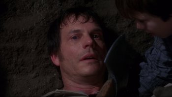Movie still from “Frailty” (2001), directed by Bill Paxton – A person holding a knife; Close Up shot, High angle