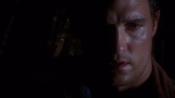 Movie still from “Frailty” (2001), directed by Bill Paxton – A man's face in the dark; Close Up shot, Over the shoulder angle