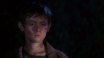 Movie still from “Frailty” (2001), directed by Bill Paxton – A young boy is looking into the distance; Close Up shot, Low angle