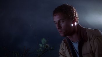 Movie still from “Frailty” (2001), directed by Bill Paxton – A man with a light in his ear looking into the distance; Close Up shot, Low angle