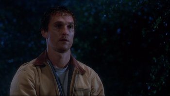 Movie still from “Frailty” (2001), directed by Bill Paxton – A man in a tan jacket looking to his left; Close Up shot, Low angle