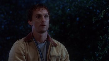 Movie still from “Frailty” (2001), directed by Bill Paxton – A man in a yellow jacket looking to his left; Close Up shot, Low angle