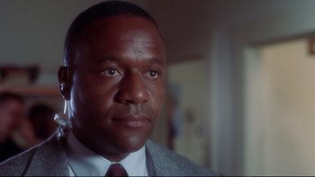 Movie still from “Frailty” (2001), directed by Bill Paxton – A person wearing a suit and tie; Close Up shot, Low angle