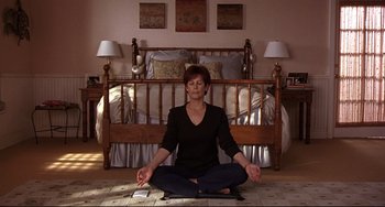 Movie still from “Freaky Friday” (2003), directed by Mark Waters – A woman sitting on the ground in a room; Medium shot, High angle