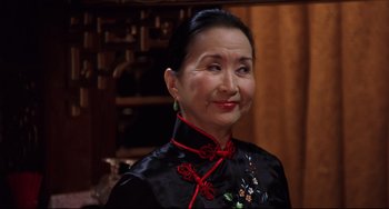 Movie still from “Freaky Friday” (2003), directed by Mark Waters – An older asian woman wearing a black dress; Close Up shot, High angle