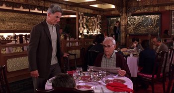 Movie still from “Freaky Friday” (2003), directed by Mark Waters – A man standing next to a man sitting at a table; Medium shot, Over the shoulder angle