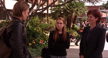 Movie still from “Freaky Friday” (2003), directed by Mark Waters – A woman standing on a sidewalk near a tree; Medium shot, Over the shoulder angle