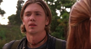 Movie still from “Freaky Friday” (2003), directed by Mark Waters – A man with long blonde hair wearing a leather jacket; Close Up shot, Low angle