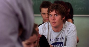 Movie still from “Freaky Friday” (2003), directed by Mark Waters – A group of young men sitting in front of each other; Medium shot, Over the shoulder angle