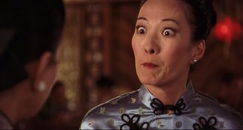 Movie still from “Freaky Friday” (2003), directed by Mark Waters – An older woman wearing a blue shirt with a bow tie around her neck; Close Up shot, Over the shoulder angle