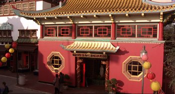 Movie still from “Freaky Friday” (2003), directed by Mark Waters – A red building with a person standing in front of it; Extreme Wide shot, High angle