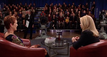 Movie still from “Freaky Friday” (2003), directed by Mark Waters – A group of people sitting in front of an audience; Wide shot, High angle