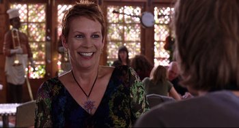 Movie still from “Freaky Friday” (2003), directed by Mark Waters – A woman with short blonde hair smiles at the camera; Close Up shot, Over the shoulder angle