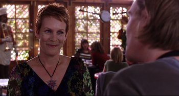 Movie still from “Freaky Friday” (2003), directed by Mark Waters – A woman with short red hair is smiling at a man; Close Up shot, Over the shoulder angle