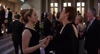 Movie still from “Freaky Friday” (2003), directed by Mark Waters – Two people in black dress talking to each other in a room; Medium shot, Over the shoulder angle