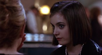 Movie still from “Freaky Friday” (2003), directed by Mark Waters – A young woman with short brown hair wearing a black dress; Close Up shot, Over the shoulder angle