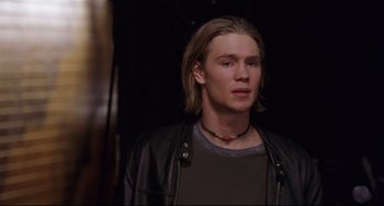 Movie still from “Freaky Friday” (2003), directed by Mark Waters – A man with blonde hair wearing a leather jacket; Close Up shot, Low angle