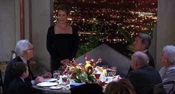 Movie still from “Freaky Friday” (2003), directed by Mark Waters – A woman standing in front of a dinner table; Medium shot, Over the shoulder angle