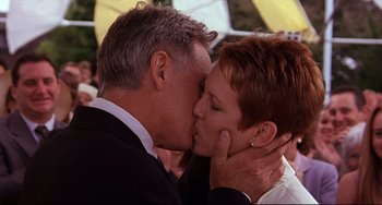 Movie still from “Freaky Friday” (2003), directed by Mark Waters – A man and a woman kissing each other in front of an umbrella; Close Up shot, Low angle