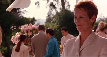 Movie still from “Freaky Friday” (2003), directed by Mark Waters – A woman standing in front of a group of people; Close Up shot, Over the shoulder angle