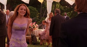 Movie still from “Freaky Friday” (2003), directed by Mark Waters – A woman in a purple dress standing next to a man in a suit; Medium shot, Over the shoulder angle