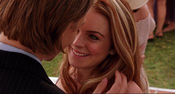 Movie still from “Freaky Friday” (2003), directed by Mark Waters – A woman's face as a man whispers into her ear; Close Up shot, Over the shoulder angle