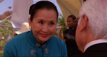 Movie still from “Freaky Friday” (2003), directed by Mark Waters – An older woman in a blue dress smiling for the camera; Close Up shot, Over the shoulder angle