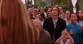 Movie still from “Freaky Friday” (2003), directed by Mark Waters – A crowd of people standing in a line; Medium shot, Over the shoulder angle
