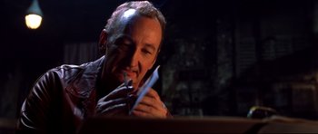 Movie still from “Freddy vs. Jason” (2003), directed by Ronny Yu – A person holding a pair of scissors; Close Up shot, High angle